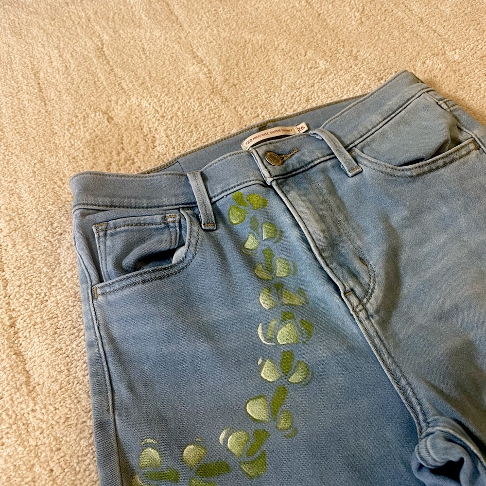 Levi’s high rise super skinny jeans - hand painted puakenikeni lei on front left